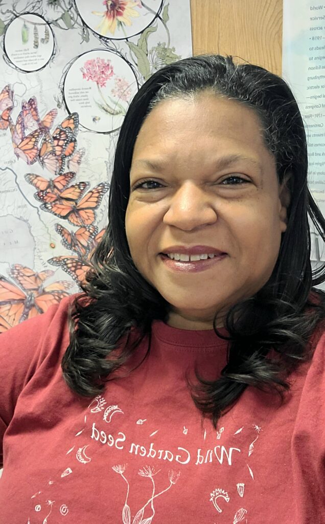 Leticia Taliafero smiling in her office wearing a red shirt.